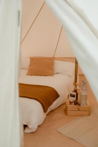 a bedroom with a bed in a tent at Glamping at Beaumont Paddocks in St. Albans