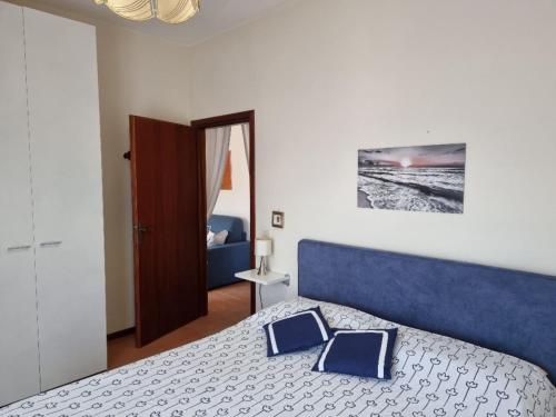 a bedroom with a bed with two pillows on it at Appartamenti RO in Follonica
