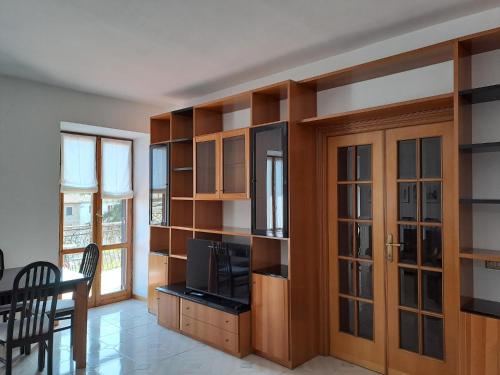 a living room with wooden shelves and a television at Casa Ai giardini in Gradoli