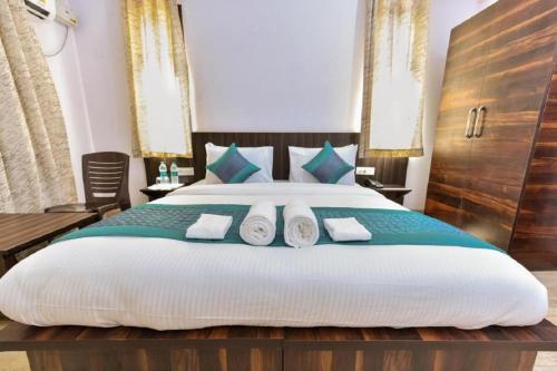 a bedroom with a large bed with towels on it at Hotel Orchid Saffron at Janakpuri in New Delhi