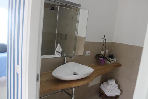 a bathroom with a white sink and a mirror at LIDO DEL FARO in Olbia