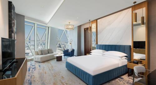 a hotel room with a bed and a television at Velero Hotel Doha Lusail in Doha