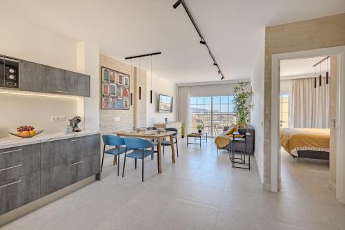 cocina y sala de estar con cama y mesa en Granada II, en Playa de las Américas