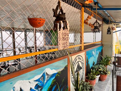 a room with a painting on the wall at Mountain View cafe in Pokhara