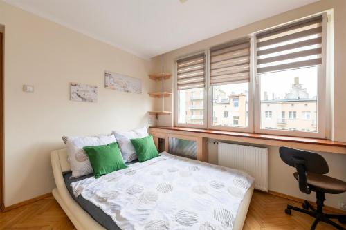a bedroom with a bed and a desk and a window at Student District in the Heart of Łódź&Free Parking in Łódź