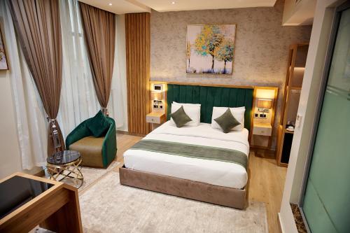 a bedroom with a large bed and a television at Watercress Signature in Lagos