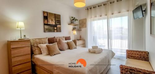 a bedroom with a bed with akeep nationals sign on it at #093 Vista das Ondas by Home Holidays in Albufeira
