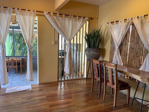 a dining room with a table and a window at Eco Lagoon in Phu Quoc