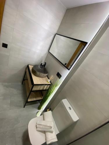 a white bathroom with a toilet and a sink at Madrid Confort Suites in Madrid
