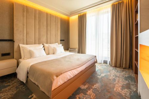 Kama o mga kama sa kuwarto sa Hotel Kocka Vrnjačka Banja