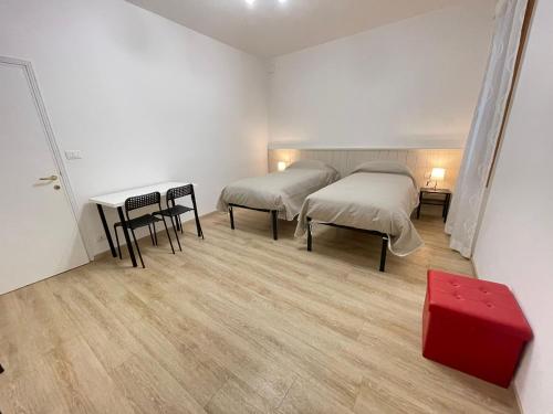 a room with two beds and a table and chairs at MONNALISA VENICE APARTMENT in Venice