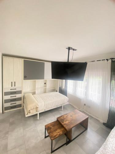 a bedroom with a bed and a table in a room at Madrid Confort Suites in Madrid