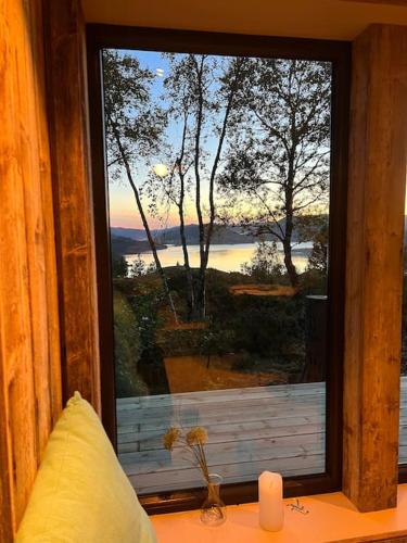 a window in a room with a view of the water at Stabbur med fantastisk utsikt! in Steinkjer
