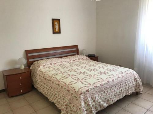 a bedroom with a bed with a blanket on it at Appartamento FAB in Follonica