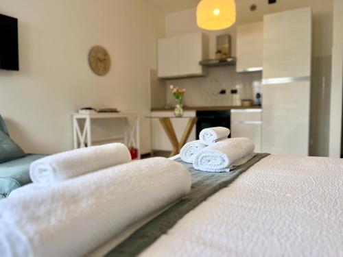 a room with a bed with towels on it at Perla Apartment Verona in Verona