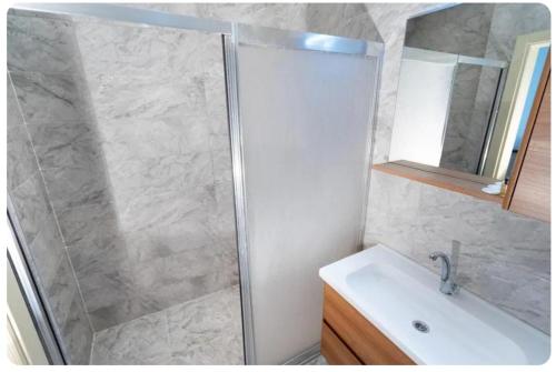 a bathroom with a shower and a sink at Telmessos in Gebze