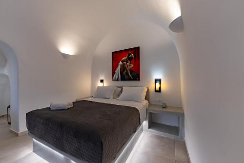 a bedroom with a bed and a table in it at Argy's Luxury Caves - Red Cave in Megalochori