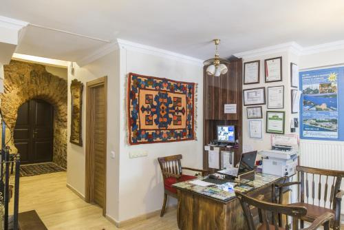 a room with a desk and a computer on a wall at Naz Wooden House Inn in Istanbul