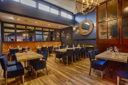 a restaurant with tables and chairs and a chandelier at The Glenside Hotel in Drogheda