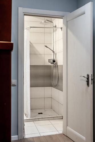 a bathroom with a shower with a glass door at Gar'is Hostel Lviv in Lviv
