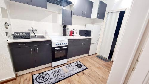 a small kitchen with a sink and a stove at Big Base Apartment in Budapest