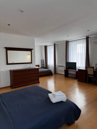 a large bedroom with a bed and a television at Готель Elisavetgrad in Kropyvnytskyi