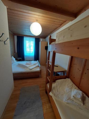 a room with two bunk beds and a lamp at Gasthof zur Post in Taxenbach