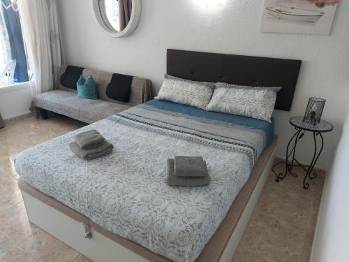 a bedroom with a large bed and a couch at SUNSET APARTMENT Las Americas in Playa Fañabe