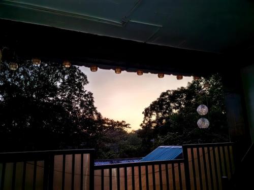 a view of the sunset through a window of a porch at DGA Traveler's Inn in Coron