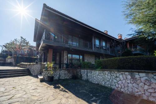 a large house with a stone wall in front of it at Villa 44 SozopoliS in Sozopol