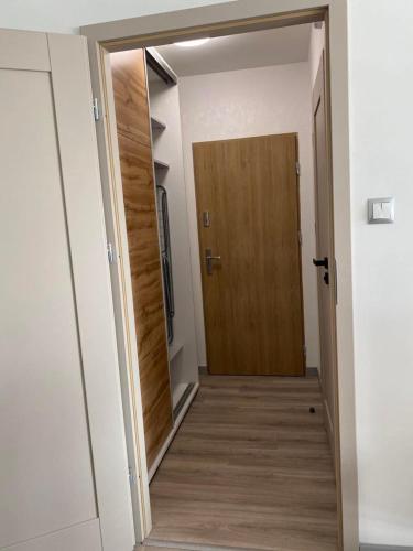 einen Flur mit Holztür in einem Zimmer in der Unterkunft Apartament pod Kotwicą in Nowa Sól