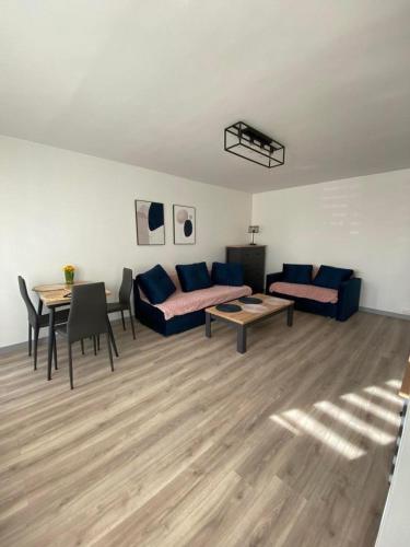 a living room with a couch and a table at Apartament pod Kotwicą in Nowa Sól