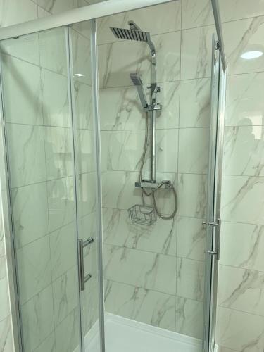 a bathroom with a shower with a glass door at Immaculate 1-Bed Apartment in Northampton in Northampton
