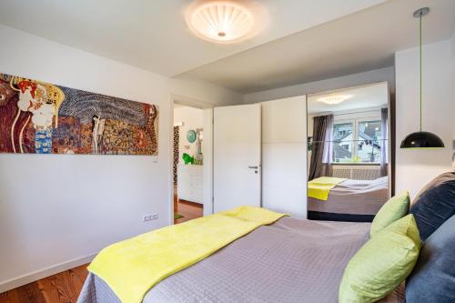 a bedroom with a bed and a mirror at Wohnung Lichtentaler Allee in Baden-Baden