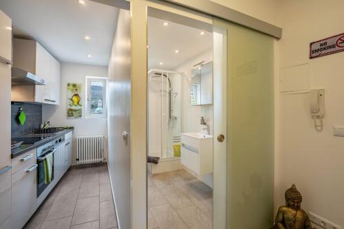 a kitchen with a walk in shower and a sink at Wohnung Lichtentaler Allee in Baden-Baden