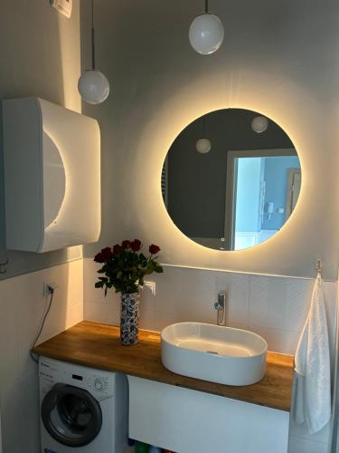 a bathroom with a sink and a mirror at Blue marina in Dziwnów