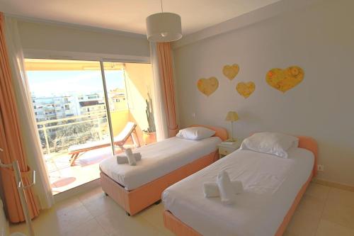 two beds in a room with hearts on the wall at Apartment 2 bedrooms 2 bathrooms clear view in Palm beach area in Cannes