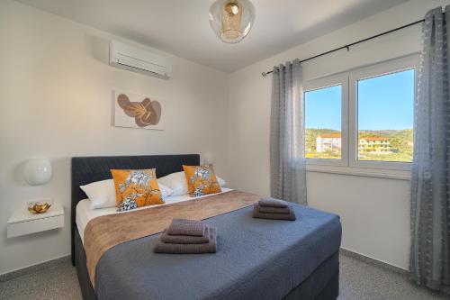 a bedroom with two beds and a large window at Angie's Rooftop Apartment in Slatine