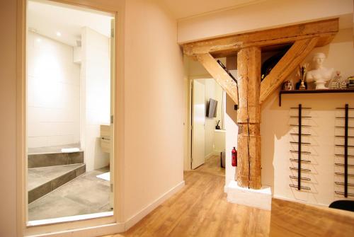 a hallway with a large mirror and wooden beams at Stunning 2 bedroom Apt. Heart of the city! in Amsterdam