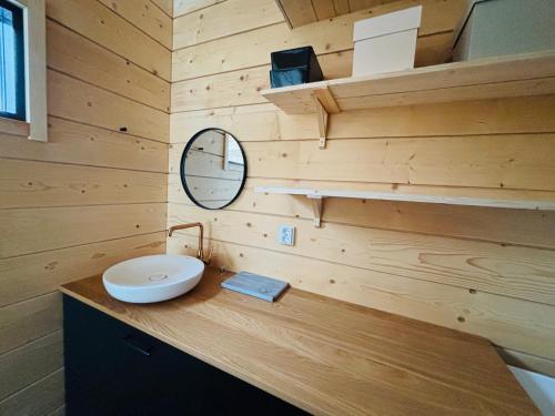 a bathroom with a toilet and a mirror on a counter at Kimmelvilla Pyhä - Ski-in, modern design and spectacular scenery in Pyhätunturi