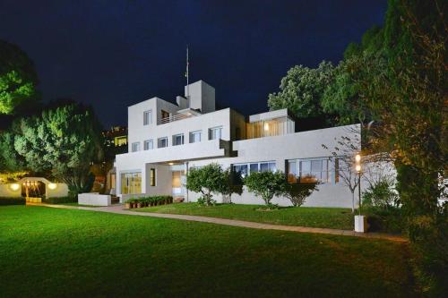 a large white house with a lawn at night at Grand Studio dans Résidence avec Piscine in Hyères
