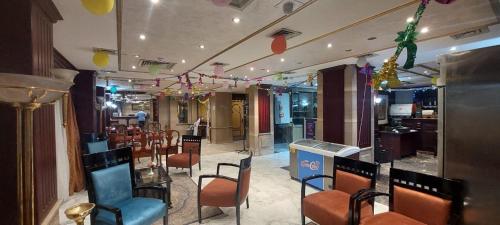 a restaurant with chairs and a bar with balloons on the ceiling at اعلاني in Luxor