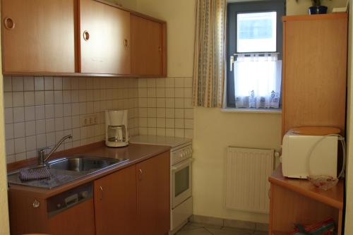 a small kitchen with a sink and a window at Haus Meeresrauschen in Rerik