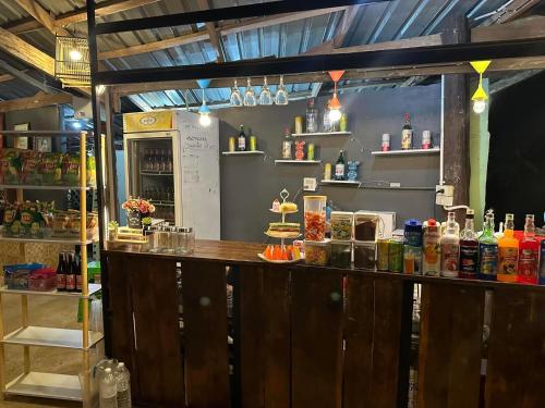 a bar in a restaurant with a lot of alcohol at ท่าเเพ รีสอร์ท in Ban Tha Phae