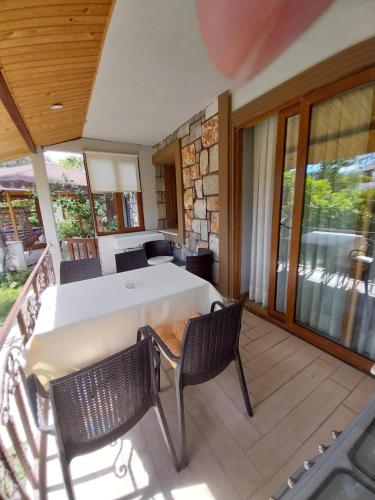 a room with a table and chairs on a deck at Jasmin Apart Otel in Göcek