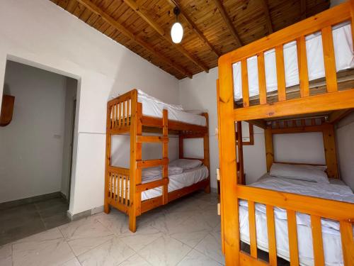 two bunk beds in a room with a ladder at Auski Hostel Dahab in Dahab