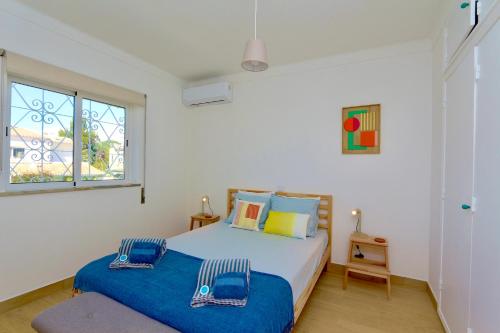 une chambre avec un lit et une fenêtre dans l'établissement Fig Villa- CleverDetails, Sleep 8, Pool, Children Playground, Ténis court, à Vilamoura