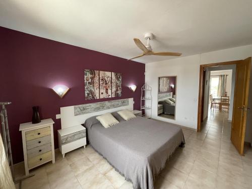 una camera con letto e ventilatore a soffitto di Mitjaneta Apartamento con piscina a Cala en Blanes