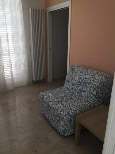 a living room with a chair and a table at B&B piazza Garibaldi in Santeramo in Colle