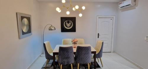 a dining room with a table and chairs at Luxury 3-Bed house in gated estate with pool Lekki in Maiyegun